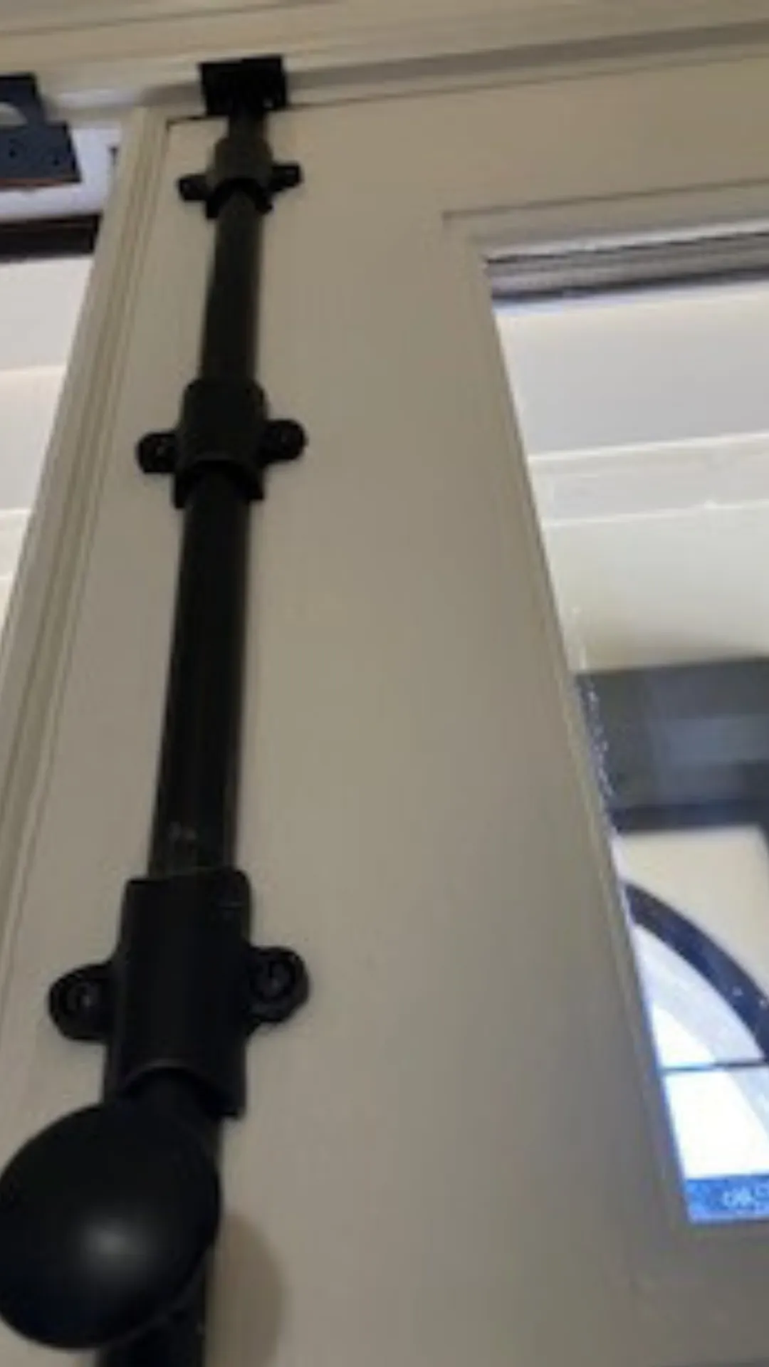 Door security bar on white door.
