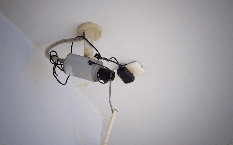 Ceiling-mounted surveillance camera with exposed wires