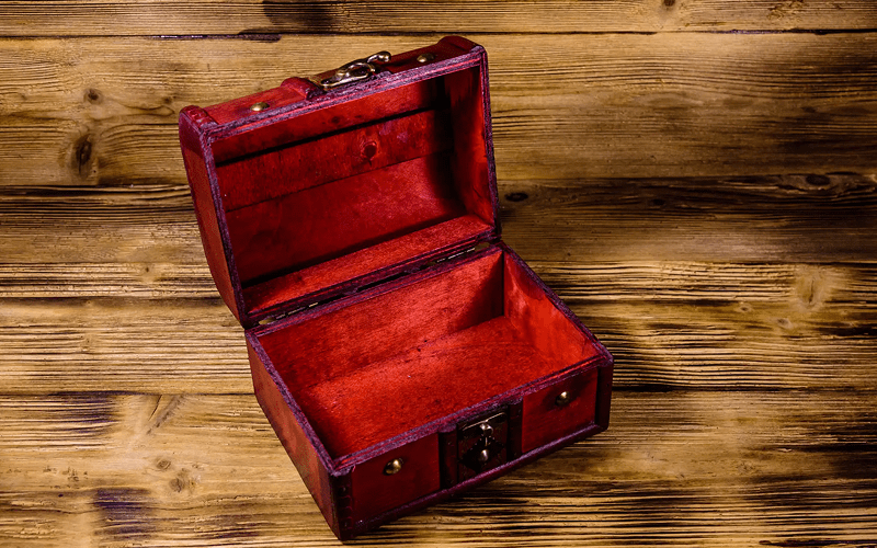 Open Empty vintage red velvet-lined box on a wooden surface